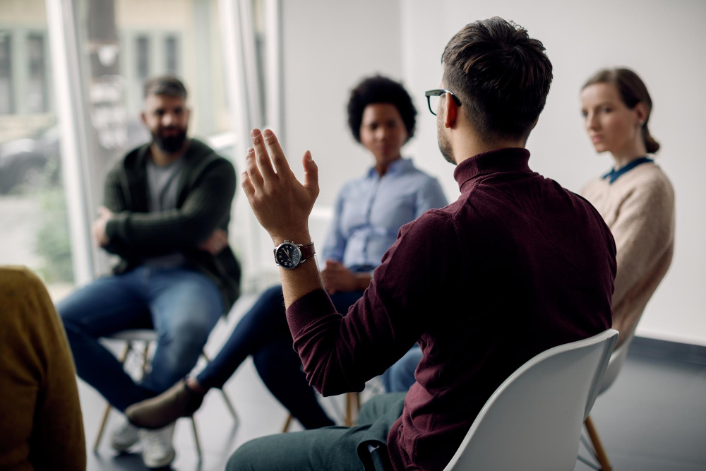 Man raising hand in focus group